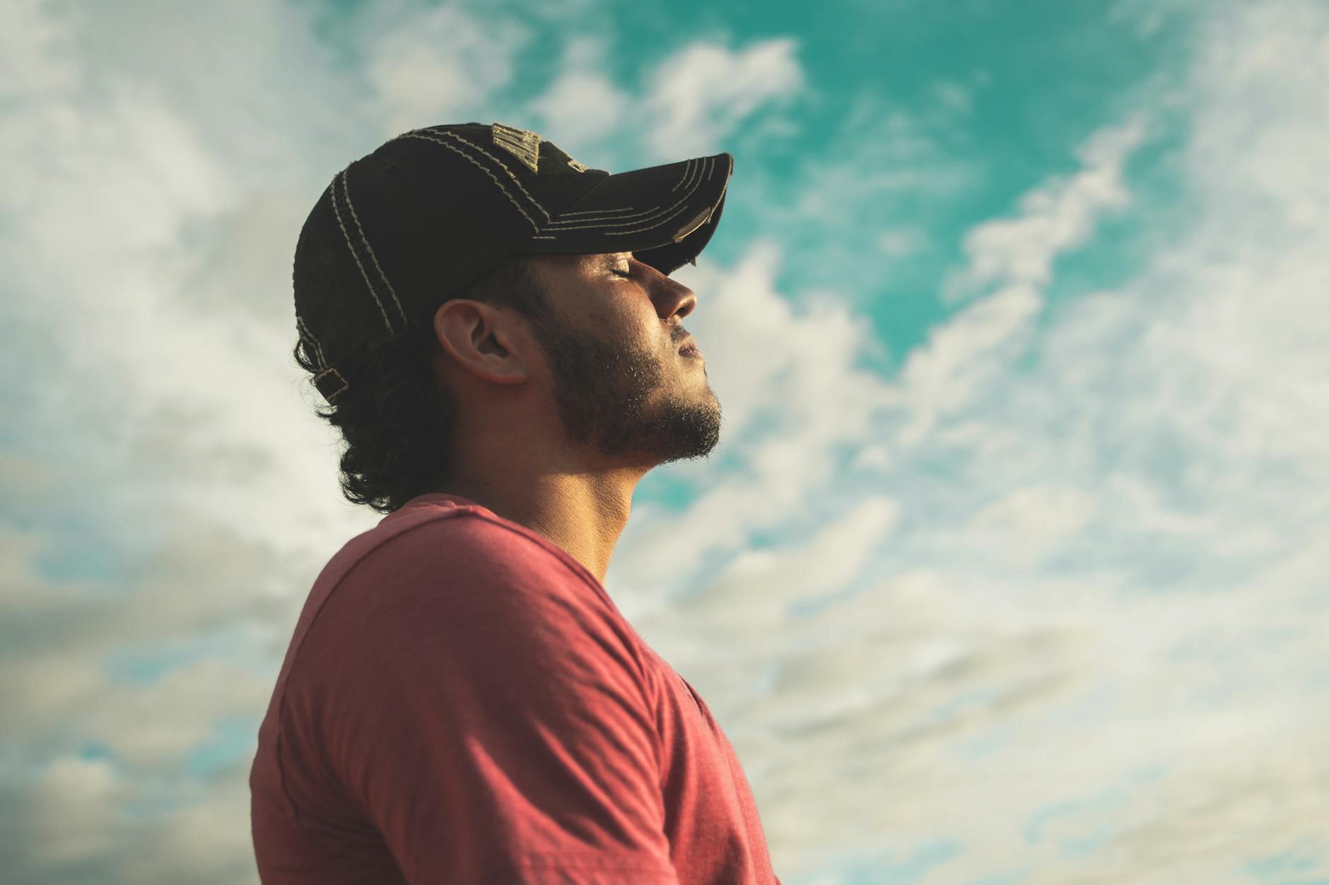 Person sitting calmly practicing breathing exercises in a peaceful setting